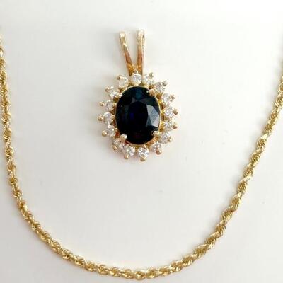 A 14kt heated sapphire and diamond pendant with yellow gold chain stamped 14kt. Chain 24â€ length and 2.6 dwt, pendant 3/4â€ length and...