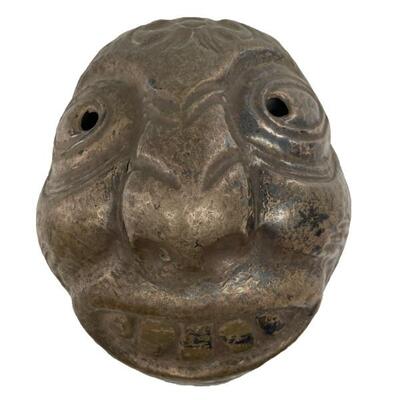 "Hand made metal mask, possibly Pacific Northwest Coast. 
Size: 8 3/4â€ high x 7 1/2â€ wide"