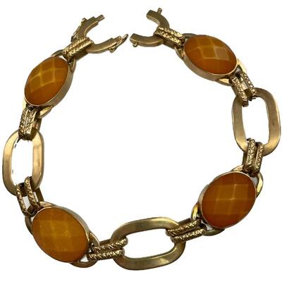 "A tested 14kt yellow gold bracelet with four bezel set oval shape standard mixed cut natural amber, measuring 14.00 x 10.00 x...