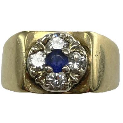 A 14kt yellow gold ring with central blue stone surrounded by four diamonds. Stone not removed from setting, offered as tanzanite. Size...