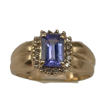 A 14kt yellow gold ring with one prong set, faceted, emerald cut tanzanite, weighing approximately .95 carats. Eighteen (18) prong set,...