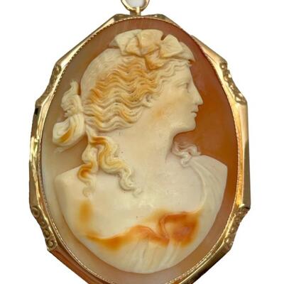 A tested 14kt rose gold pendant with carved shell cameo, signed verso. Pendant 2 1/4â€ x 1 /2â€. 8.8 dwt.