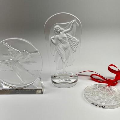 "1) â€œLalique Society of Americaâ€, 1992 plaque. Ice skater with arms outstretched. 4â€ 
â€¨2) â€œLalique Society of Americanâ€...