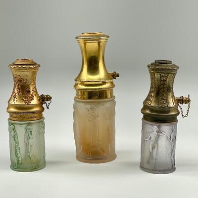 "1) Atomizer. â€œR. Lalique Made in Franceâ€ embossed at base. Le Parisien. Gilt metal top. Frosted glass base with nudes and...