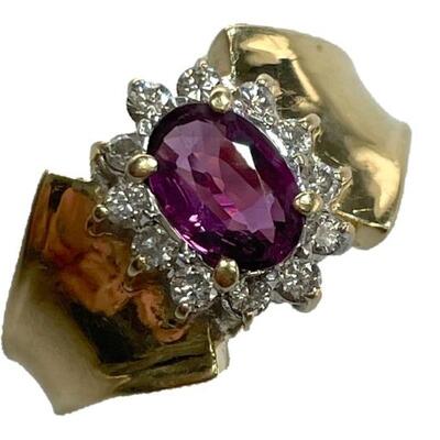 "A 14kt yellow and white gold ring with one oval prong shape standard natural almandine garnet, measuring 7.00 x 5.00 x 3.25mm,...