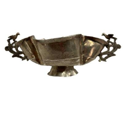 "Hand wrought silver double handled cup raised on circular foot. Quatrefoil in form, with two pierced foliate handles each...
