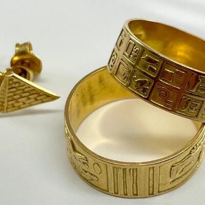 Two 14kt yellow gold bands, each decorated with Egyptian images or Hieroglyphs. Both size 9 1/2. Includes a pair of 14kt yellow gold...