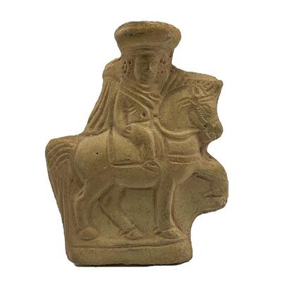 "Roman, mold-made pottery figure depicting a prancing horse and rider. Rider is wearing a hat and flowing cloak. Verso is smooth...