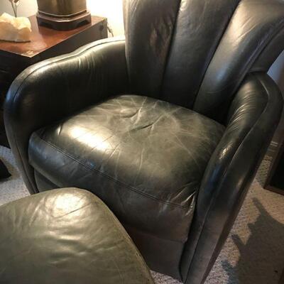Two Slate gray leather swivel rockers and one ottoman by Leather Plus 