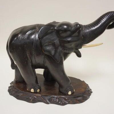 1060	LARGED CARVED WOODEN ELEPHANT ON CARVED WOODEN BASE, APPROXIMATELY 17 IN HIGH
