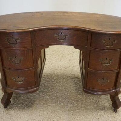 1043	OAK KIDNEY SHAPED DESK W/REEDED FRONT COLUMNS, APPROXIMATLEY 48 IN X 3 IN X 31 IN HIGH, STAINING ON TOP SURFACE
