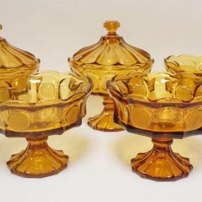 1081	5 FOSTORIA AMBER COIN GLASS COMPOTES, TWO HAVE LIDS. APP. 10 IN H INCLUDING LID
