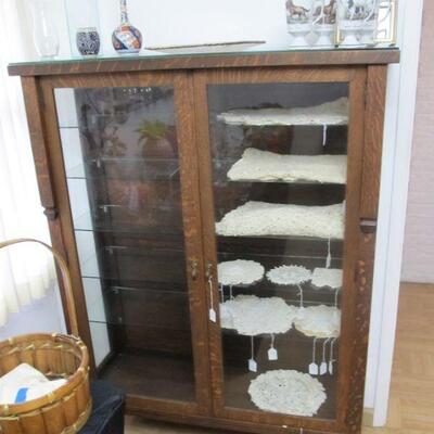 Antique tiger oak glass display cabinet, with handmade lace doilies & table runners.