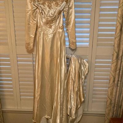 1940â€™s â€¢ Satin â€¢ Wedding Gown â€¢ Illusion Neckline â€¢ Beaded Bodice â€¢ Button Back â€¢ Chapel Train â€¢ 1,050 US