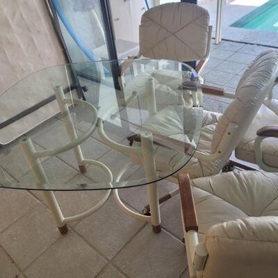 another table with glass top and four chairs