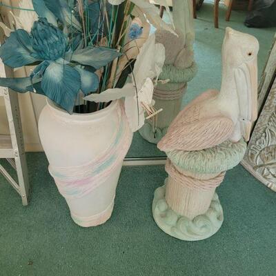 Pelican statue and vase with flowers