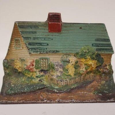 1165	ANTIQUE CAST IRON COTTAGE W/FLOWERS DOORSTOP, APPROXIMATELY 6 IN X 8 1/2 IN

