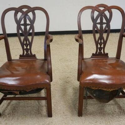1114	PAIR OF CARVED MAHOGANY ARMCHAIRS W/LEATHER SEATS, WEBBING NEEDS TO BE REATTACHED UNDERNEATH
