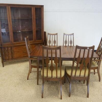 1187	MIDCENTURY MODERN WALNUT DINING ROOM SET INCLUDES BREAKFRONT, TABLE W/ LEAVES & SIX CHAIRS. SOME VENEER LOSS AND UPHOLSTERY WEAR

