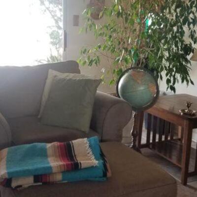 over stuffed club  chair and foot stool with standing globe