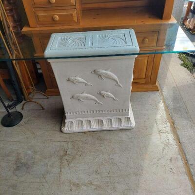 very nice glass top table with dolphins on the base