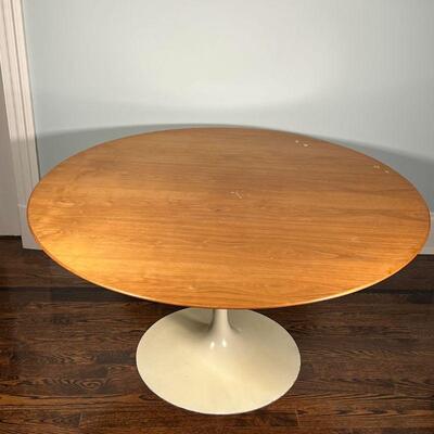 EERO SAARINEN TULIP TABLE | Tulip dining table with a wood top over a white base; h. 28-1/2 x dia. 54 in. [some wear to top surface and...