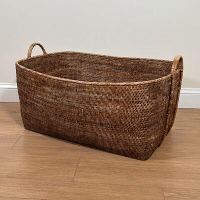 LARGE WICKER BASKET | Large basket with carrying handles, appearing in great condition and sturdy; h. 17-1/2 x w. 32-1/2 x d. 24-1/2 in.