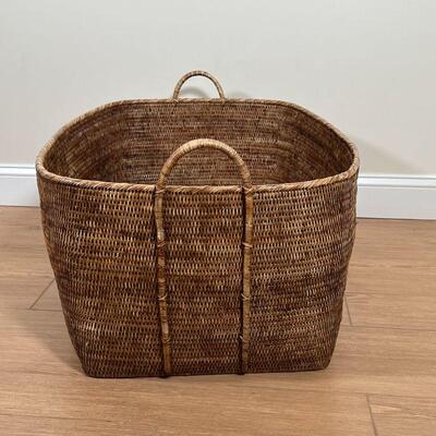 LARGE WICKER BASKET | Large basket with carrying handles, appearing in great condition and sturdy; h. 17-1/2 x w. 32-1/2 x d. 24-1/2 in.