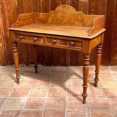 ANTIQUE WASH STAND | With 3/4 gallery top over two drawers over turned tapering legs; h. 39-3/4 x w. 42 x d. 20 in.