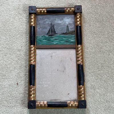 ANTIQUE LOOKING GLASS | Antique gilt and painted wood frame with a painted glass panel showing a seascape with a ship and lighthouse over...