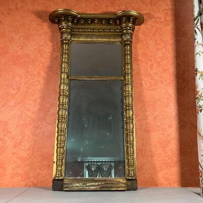 GILT PIER MIRROR | With two mirrored panels in a gilt carved frame; h. 43-1/4 x w. 25-1/2 x d. 5-1/2 in.