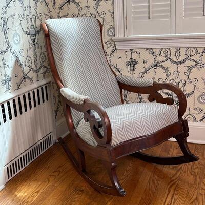 UPHOLSTERED ROCKING CHAIR | Antique carved wood rocking chair with cushioned seat, backrest, and arm rests with nice newer upholstery in...