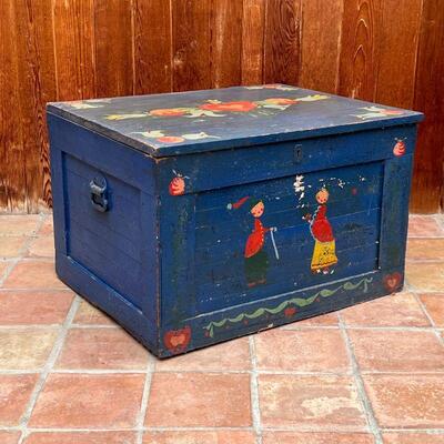 PETER HUNT CHEST | Hinged lid blanket chest with overall blue paint and heart and foliage motifs, with applied wallpaper to interior...