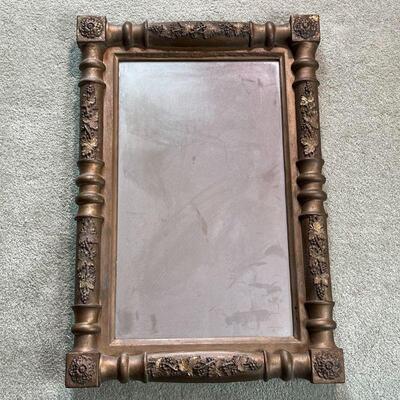 GILT CARVED MIRROR | Antique framed mirror, carved wood with foliate motifs; overall 25 x 17 in.