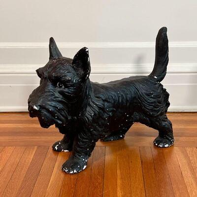 PAINTED DOG FIGURE | Small black schnauzer, black painted composition; h. 14-3/4 x w. 18-1/2 x d. 8 in. [one front foot cracked, with...