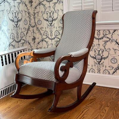 UPHOLSTERED ROCKING CHAIR | Antique carved wood rocking chair with cushioned seat, backrest, and arm rests with nice newer upholstery in...