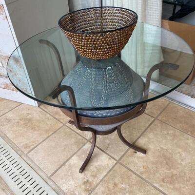 Glass top & iron table w/pottery piece in center