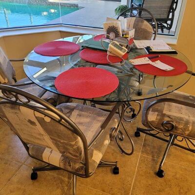 breakfast nook set of a glass top table and 4 chairs
