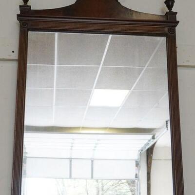 1089	WALNUT HANGING MIRROR WITH REEDED COLUMNS, FINIALS AND CARVED FLOWERS AT CREST. APPROXIMATELY 24 IN X 26 IN HIGH
