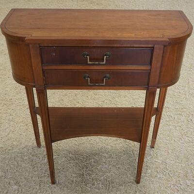 1086	SMALL MAHOGANY 2 DRAWER HECKMAN DEMI LUNE STAND. APPROXIMATELY 28 IN X 11 IN X32 IN HIGH
