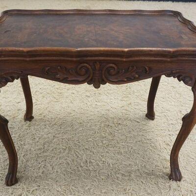 1082	CARVED WALNUT OCASSIONAL TABLE WITH BURL WOOD TOP SURFACE. APPROXIMATELY 27 IN X 16 IN X20 IN HIGH

