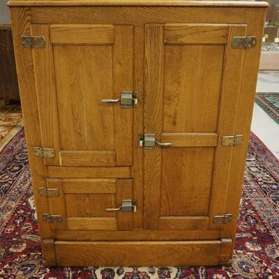 1053	LARGE OAK CARVED DOUBLE SIDE BY SIDE WITH ORNATE BRASS PULL AND HARDWARE. 3 DRAWERS, I DOOR AND FALL FRONT CENTER DESK....