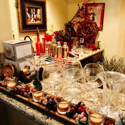 Bar area full of accessories from Red Vases to Candles to Glasses