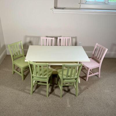 KIDS TABLE & CHAIRS | White play table with cubby storage, with three pink chairs and three green chairs; table h. 22-1/2 x w. 48 x d. 27...