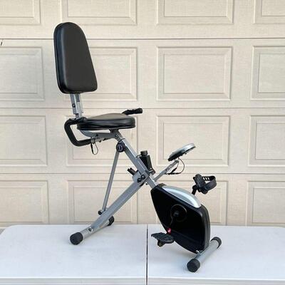 EXERCISE BIKE | Hammacher Schlemmer seated exercise bike, seat folds down for compact storage [with loss to one pedal]