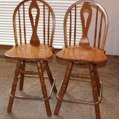 Solid wood and sturdy swivel barstools are in excellent condition.