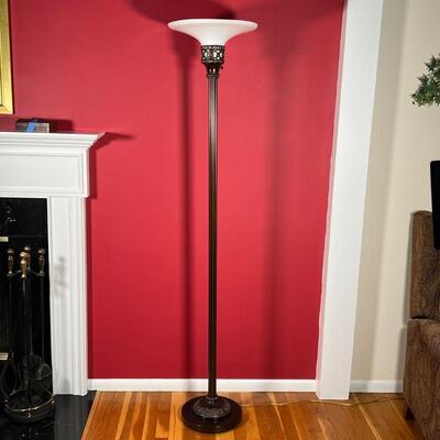 FLOOR LAMP | Bronzed column floor lamp with a white milk glass top and scroll openwork accents; h. 68-1/2 in.