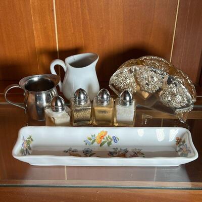 (8pc) MISC TABLE ITEMS | 4 spice shakers, a tin and ceramic creamer, long floral dish (l. 8-1/4 in.), and silver plated napkin holder 