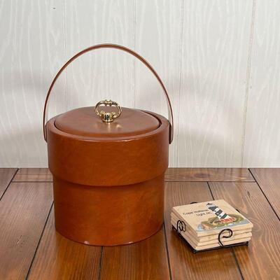LEATHER WRAPPED ICE BUCKET | Wrapped in brown leather; h. 12-1/2 in. (over handle); plus a set of lighthouse coasters 