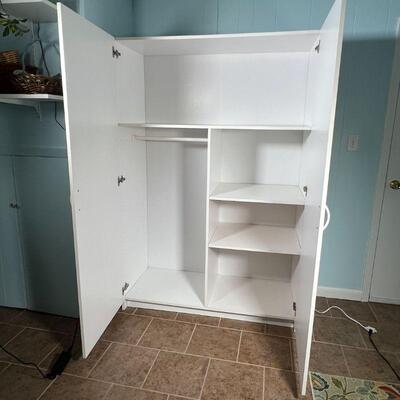 WHITE STORAGE CABINET | Wide double door pantry / cabinet, with shelves and hanging space; h. 71-1/2 x w. 48 x d. 20-1/2 in.